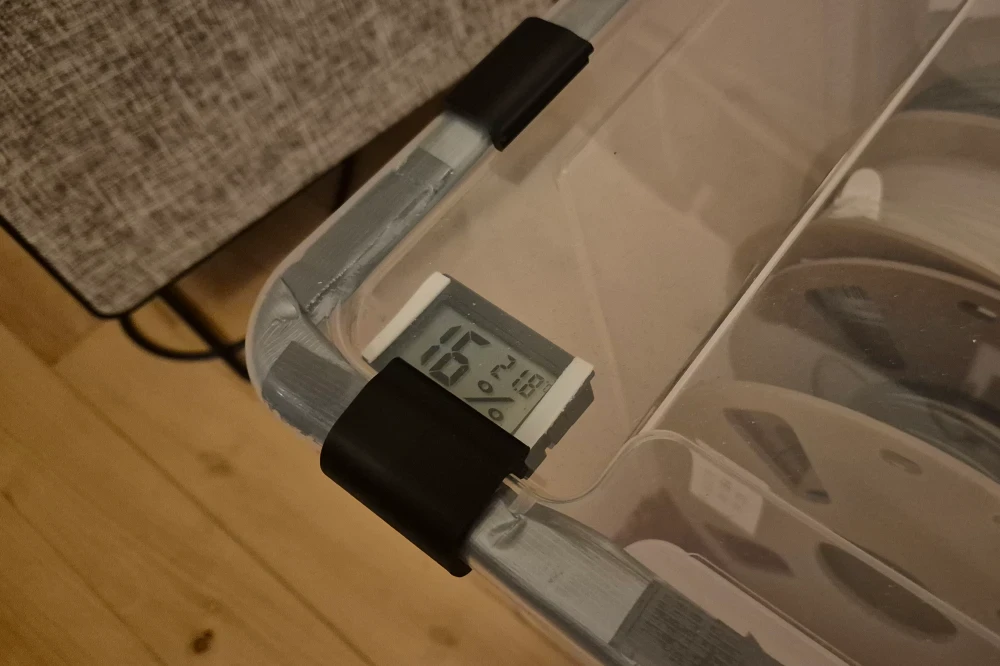 Close-up of cheap hygrometer and make-shift duct-tape gasket.