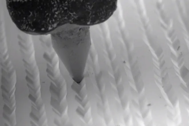 Close up view of needle slotting into the grooves. From Applied Science on YouTube.